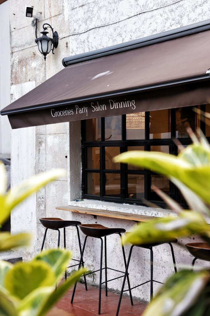 Cozy outdoor cafe bar setup with rustic charm and inviting foliage.