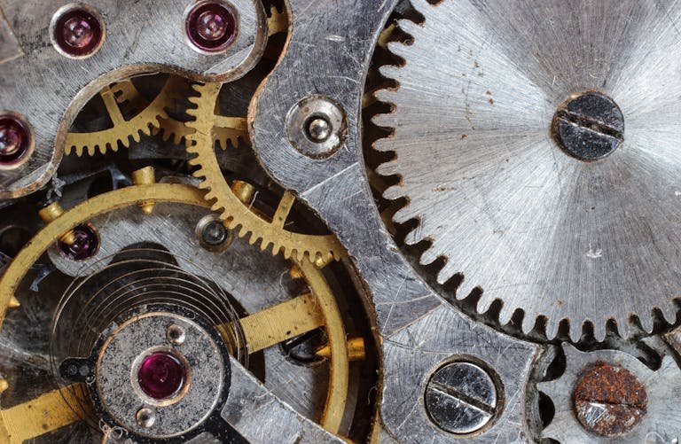 Detailed close-up of interlocking gears and cogs in a complex mechanical system.